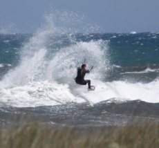 Tim Stockman kite boarding in the shore break